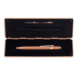 Caran'dAche 849 roller ballpoint pen in a brut rose case